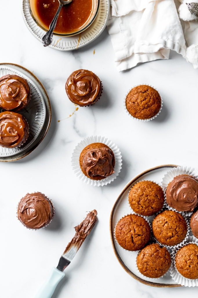 overhead pumpkin cupcakes with chocolate frosting